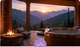 A peaceful mountain retreat with a hot tub at sunset